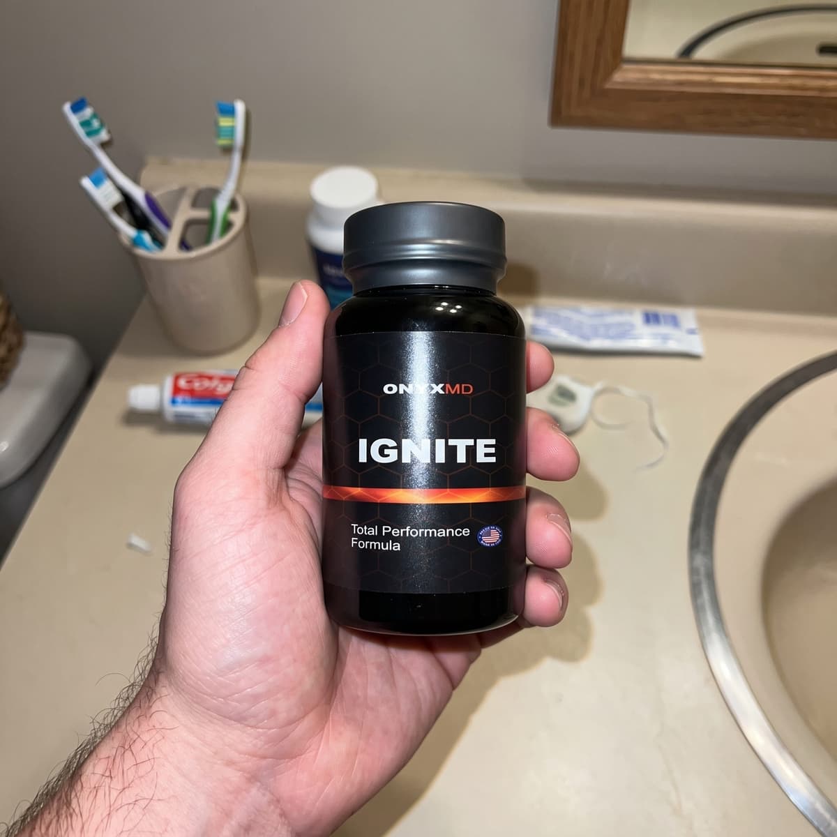 Customer holding an OnyxMD Ignite bottle